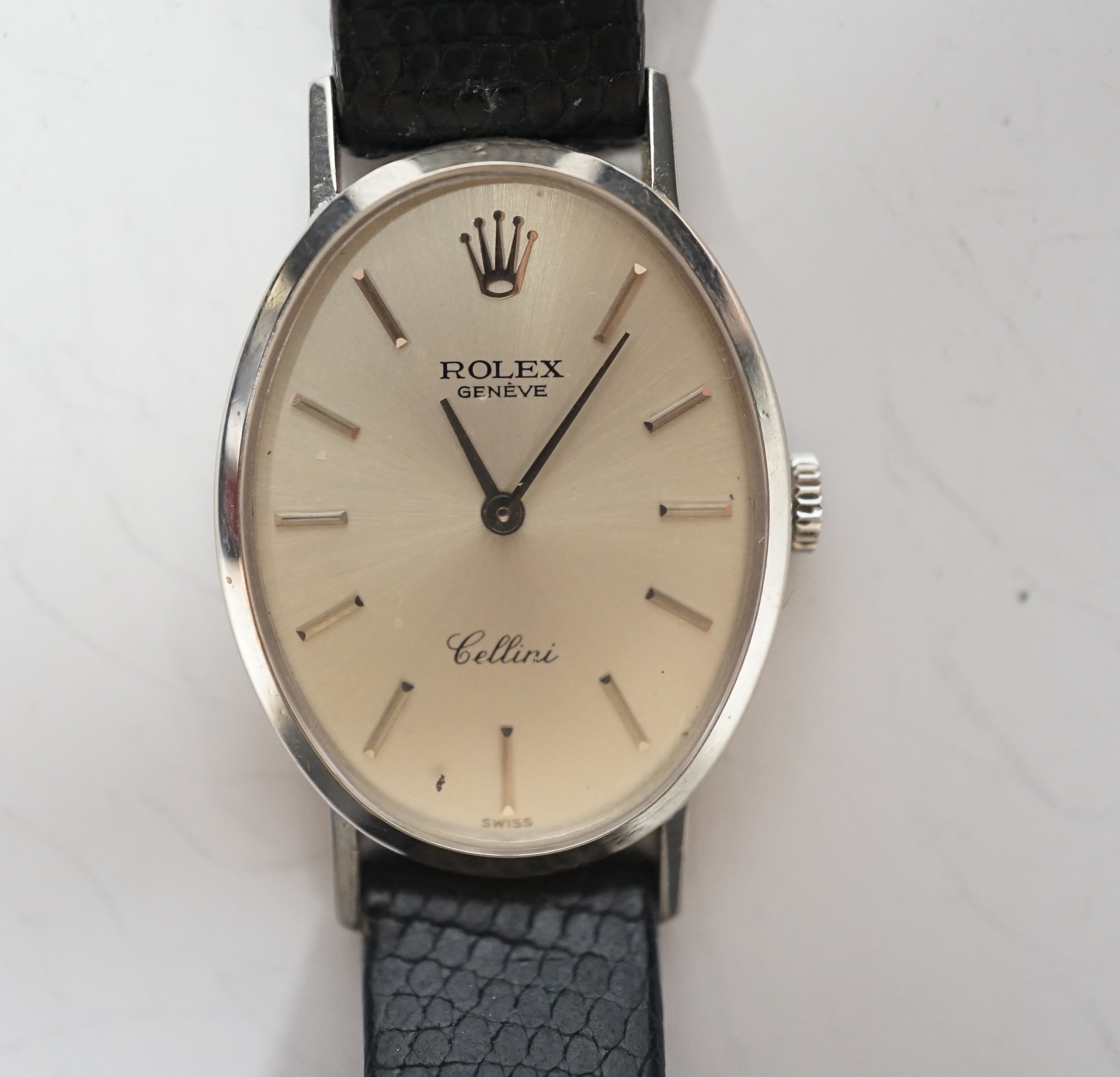 A lady's modern 18k Rolex Cellini manual wind oval wrist watch, with baton numerals, on a leather Rolex strap with 18k Rolex buckle, with original purchase receipt , Rolex Guarantee and Service statement, no box, case di